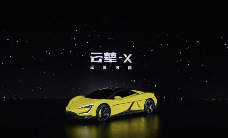 Presentación de carro de color amarillo en el evento de tecnología de BYD, atrás se encuentra una pantalla gigante de fondo negro 